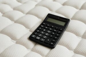 Calculator on a textured mattress surface.